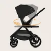 A black stroller is shown with animated arrows indicating its 360-degree swivel feature. Produktbild-Vorschau