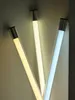 Three LED light tubes with different color temperatures are shown leaning against a wall. Produktbild-Vorschau
