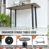 A table with four black legs is shown in a room. There are three inset images below the table showing details of the legs and a wrench. Voir les images du produit