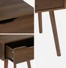 Collage of close-up shots of a wooden nightstand with a drawer, showing the wood grain and drawer details, and a shot of the legs. Produktbild-Vorschau
