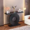 A modern console table with a geometric base, decorated with a bull skull sculpture, flowers in a vase, and candles. Náhľad obrázku produktu