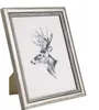 A silver picture frame with a drawing of a deer inside, placed on a white background. Produktbild-Vorschau
