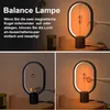 A collage of images showing a magnetic balance lamp being turned on and off by moving magnetic spheres. Produktbild-Vorschau