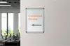 A sign on a wall pointing towards a conference room. Voir les images du produit