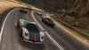 A group of sports cars racing on a winding mountain road. Produktbild-Vorschau