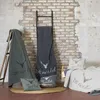 A collection of blankets and pillows with a deer motif, arranged in a cozy setting against a brick wall. Produktbild-Vorschau