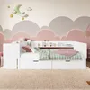 A white youth bed with storage drawers and shelves, set against a whimsical cloud-themed wall. Produktbild-Vorschau
