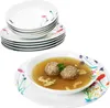 A stack of decorative plates and a bowl of soup with meatballs. Produktbild-Vorschau
