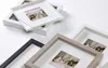 Several photo frames are arranged on a white surface. Voir les images du produit