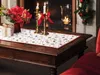 A festive Christmas table setting with a runner, candles, and flowers. Produktbild-Vorschau