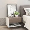 A bedside table with decorative items next to a bed. Produktbild-Vorschau