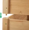 A close-up view of two wooden planter boxes being assembled. Produktbild-Vorschau