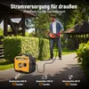 A man is using a hedge trimmer in a garden, powered by a portable generator. Podgląd zdjęcia produktu