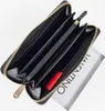 An open black wallet with gold zipper and interior compartments, with a white card with the VALENTINO logo partially visible. Produktbild-Vorschau