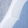 A close-up view of layered felt material in blue, white, and light gray, showing the texture and stitching. Produktbild-Vorschau