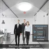 Three people in business attire walking in a modern office hallway with a ceiling light. Náhľad obrázku produktu