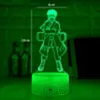 A 3D LED night light shaped like the anime character Naruto, glowing green, on a dark surface with some blurred bottles in the background. Produktbild-Vorschau