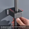 A hand is shown adjusting a shower rod holder against a wall. Podgląd zdjęcia produktu