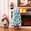 A decorated Christmas tree and a plush bear are displayed in a home setting with a fireplace in the background. Náhled obrázku produktu
