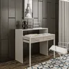 A modern desk with drawers and a chair in a room with dark paneled walls and a patterned rug. Náhled obrázku produktu