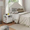 A bedroom scene with a nightstand next to a bed. Anteprima dell’immagine prodotto