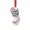 A ceramic Christmas boot ornament hanging from a red ribbon. Produktbild-Vorschau
