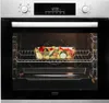 An open oven with a glass dish of chopped vegetables on a rack. Produktbild-Vorschau