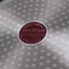 Close-up of the bottom of a pot with a red circular emblem. Produktbild-Vorschau