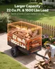 A man is loading firewood into a trailer in a backyard setting. Anteprima dell’immagine prodotto