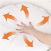 A hand is pressing into a soft, white cushion or pet bed, with orange arrows indicating airflow or softness radiating outwards. Náhled obrázku produktu