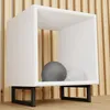 A white cube shelf with black metal legs, containing two decorative spheres, set against a slatted wooden background. Podgląd zdjęcia produktu