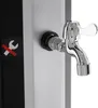 A close-up of a faucet on a silver and black outdoor shower column, with a warning symbol on the left. Náhled obrázku produktu