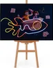 Children playing with a cardboard box rocket, decorated with neon lights. Produktbild-Vorschau