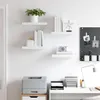 A clean, modern office or study space with floating shelves displaying decorative items and books, a printer on a cabinet, and a desk with a lamp and office supplies. Náhled obrázku produktu