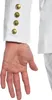 Close-up of a person's hand and the sleeve of a white jacket with gold buttons. Produktbild-Vorschau