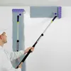 A person is painting a wall with a roller extension pole. Podgląd zdjęcia produktu