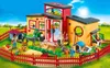 A Playmobil animal hotel playset with figures and animals in a grassy outdoor setting. Produktbild-Vorschau
