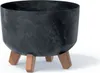 A dark gray, round planter with a marbled texture sits on three brown wooden legs against a white background. Anteprima dell’immagine prodotto