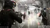 A group of soldiers in a futuristic hallway, engaged in a firefight with sparks flying. Produktbild-Vorschau