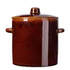 A brown ceramic pot with a lid and handles, isolated on a white background. Voir les images du produit