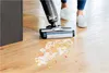 A person is using a vacuum cleaner to clean up a spill on a wooden floor. Voir les images du produit