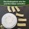 A white pasta cutter and freshly made pasta shapes are laid out on a dark surface. Produktbild-Vorschau