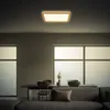 A modern living room with a large window, a dining table and chairs, and a sofa. Produktbild-Vorschau