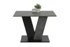 A dining table with a V-shaped base and a plant on top, presented on a white background. Produktbild-Vorschau