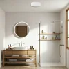 A modern bathroom with a wooden vanity, sink, mirror, and shower. Produktbild-Vorschau