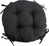 A round, black seat cushion with ties. Produktbild-Vorschau