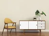 A modern armchair and a sideboard with decorative plants and a vase in a room. Podgląd zdjęcia produktu
