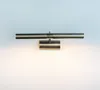 A modern picture light fixture mounted on a white wall. Podgląd zdjęcia produktu