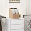 Desk organizers filled with papers are placed on top of a white drawer unit, next to a framed picture. Voir les images du produit
