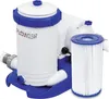 A white and blue swimming pool filter pump with a filter cartridge. Voir les images du produit